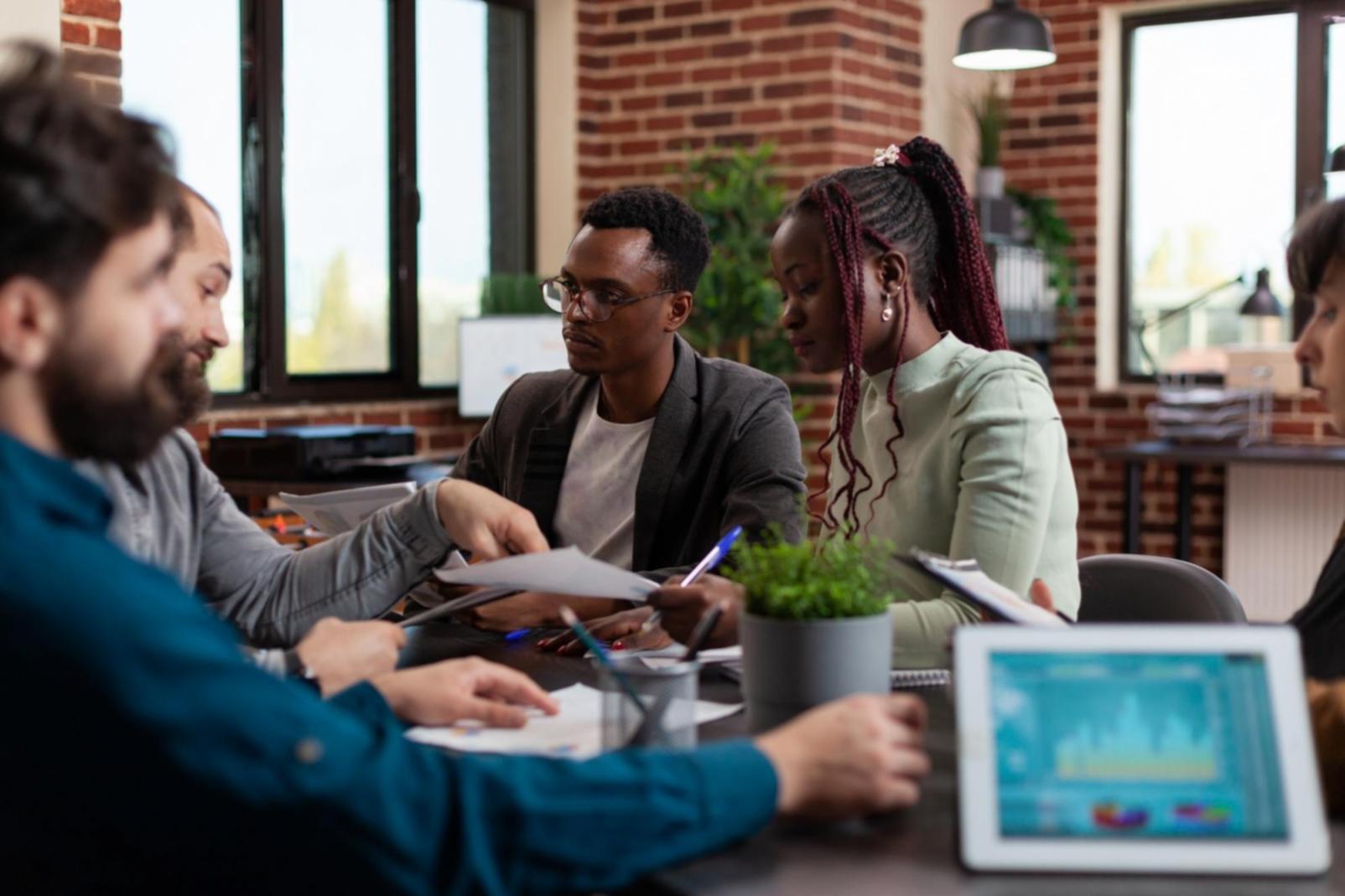 Financial documents and analysis materials spread across a workspace